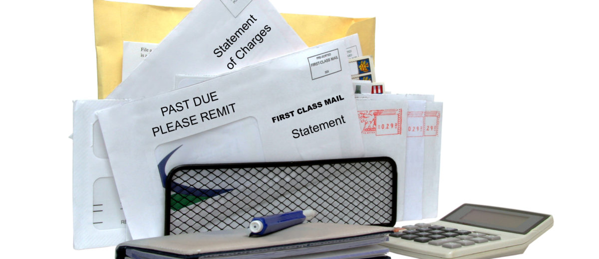 Monthly bills with checkbook and calculator